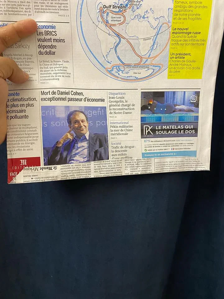 White Newsprint - Flat bottom - Envelope with foldable flap - 10 * 14 Inches showing printed newspaper texture held open in hand