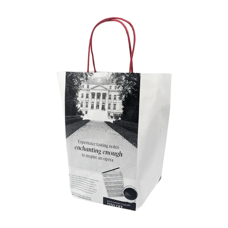 White News Paper Bags - Medium size - Short Version with black and white print and red twisted handles standing upright