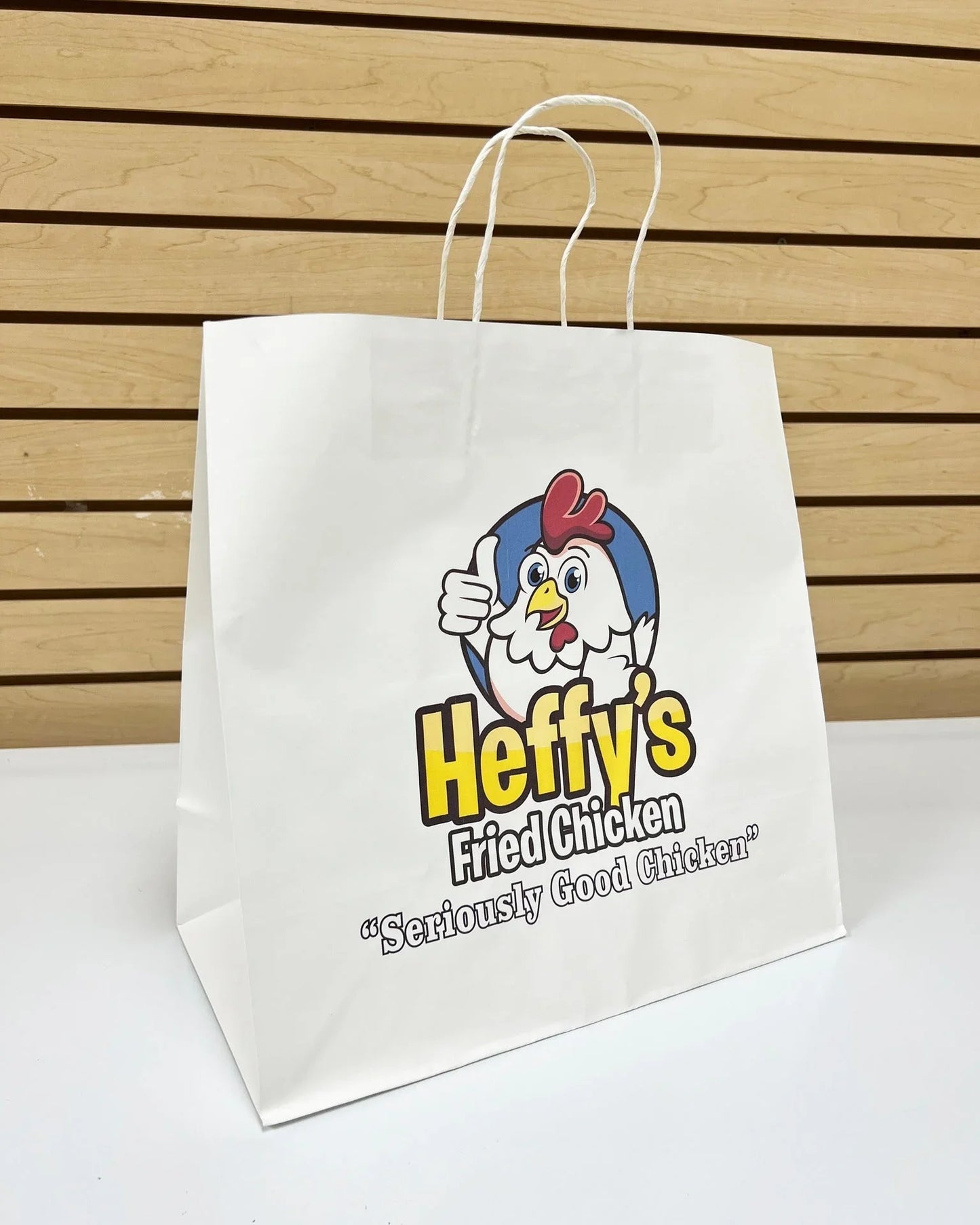 Logo printing for 8.5x4.75x10.25 White Paper Bags with custom chicken restaurant logo and twisted handles displayed