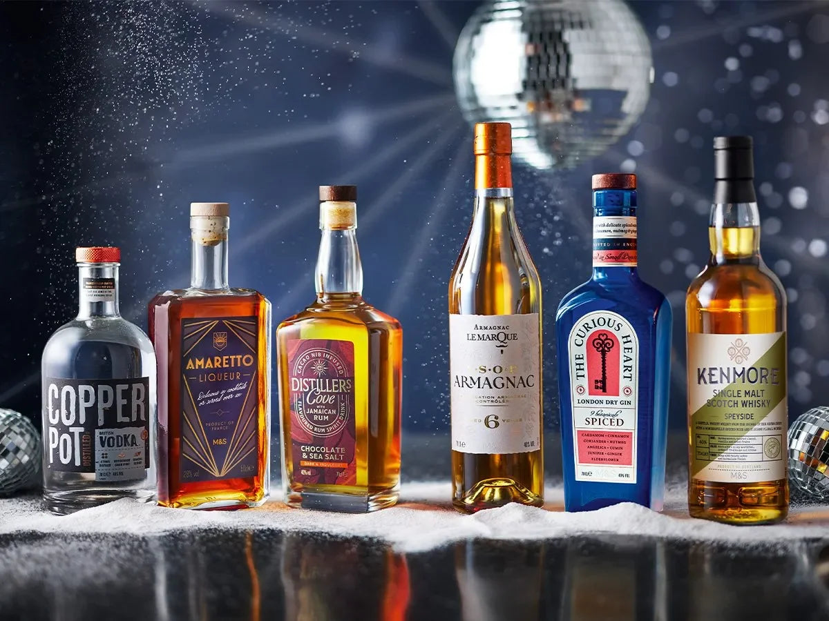 Premium Whiskey Bottles | Glass or PET Plastic | Cork or Screw Cap Options shown with assorted labeled liquor bottles on reflective surface