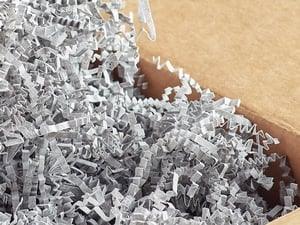 Crinkle paper shreds- Gray, close-up showing acid-free, single-layer shredded packing material inside a cardboard box