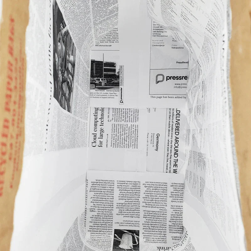 Inside view of eco-friendly recycled paper bag with newspaper print, sustainable packaging