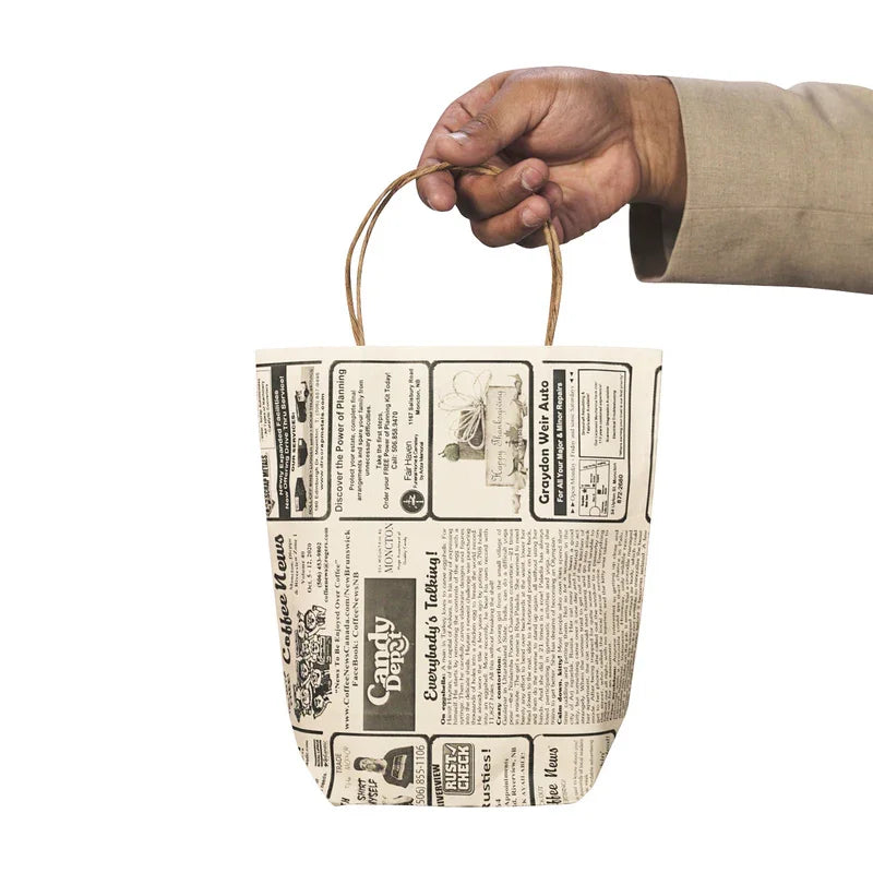 Hand holding eco-friendly recycled paper bag with newspaper print, Greenii packaging