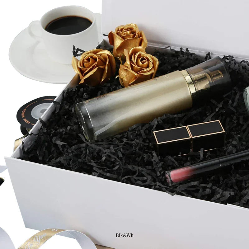 Crinkle paper shreds - Black, shredded black paper filler used as cushioning and decorative packaging in a gift box setting