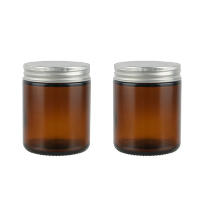 Empty Candle Jars | Wholesale Glass Containers | Eco Friendly Candle Packaging with amber glass and silver metal lids side by side